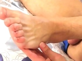 Teen rubs his oily feet